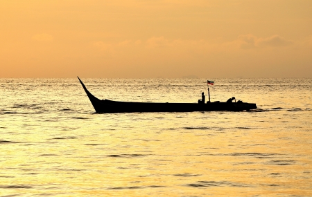 Silhouette of Fishemen on a moving boat の写真素材
