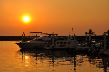 Silhouettes of boats at sunset の写真素材