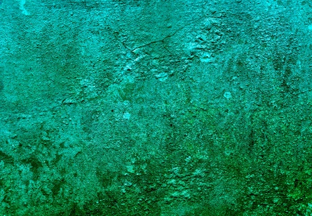 Green painted wall with grain and texturesの写真素材
