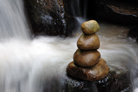 Stacked zen stones and waterfallの写真素材