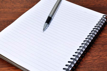 Pen and Notebook on a deskの写真素材