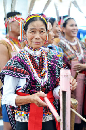 KOTA KINABALU, MALAYSIA - MAY 30: Woman in traditional Kadazan Dusun costume playing bamboo music during Harvest Festival celebration May 30, 2014 in Kota Kinabalu, Sabah Borneo, Malaysia.のeditorial素材