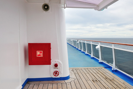 White painted wall of a luxury cruise ship exterior image, with fire hose reel on a wall.の写真素材