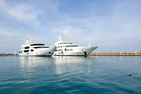 Two white luxury boats at the marinaの写真素材