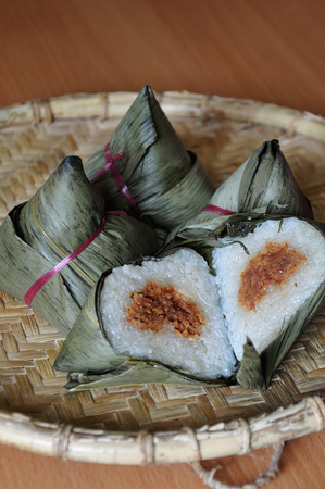 Chinese rice dumplings  or zongzi  a traditional Chinese food, made of glutinous rice stuffed with different fillings and wrapped in bamboo, reed or large flat leaves. Its served during festival.の写真素材