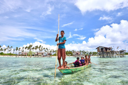 SABAH MALAYSIA  APRIL 19: Unidentified Bajau Laut kids on a boat in Maiga Island on April 19 2015. They inhabit villages built on stilts in the middle of sea boat is the main transportation here.のeditorial素材