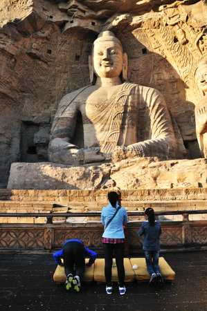 DATONGSHANXI CHINA  OCT 10: Unidentified people praying in front of Yungang Grottoes on Oct 8 2012 in Datong Shanxi China. Yungang Grottoes is World cultural heritage.のeditorial素材