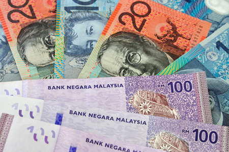 A close-up photograph of Australian dollars and Malaysia's ringgit Malaysia currency.