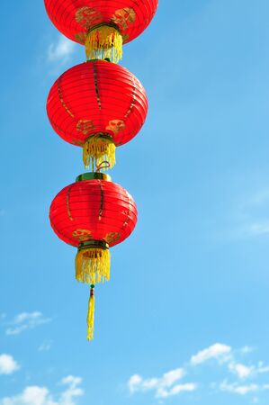 Red Chinese lantern against blue skyの写真素材