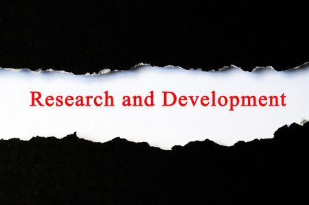 Research and development concept word under torn paperの写真素材