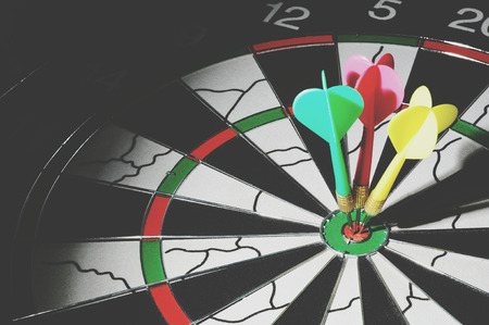 Light focused on a three darts on bulls eye, retro styleの写真素材