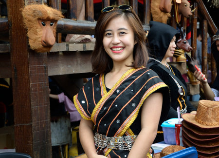KOTA KINABALU, MALAYSIA - MAY 31, 2016:  Smiling Malaysian woman in traditional costumes during Sabah Harvest festival celebration in Kota Kinabalu, Sabah Borneo, Malaysia.のeditorial素材