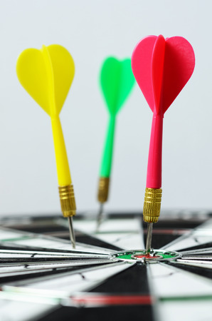 Selective focus of darts hitting on dartboard.の写真素材