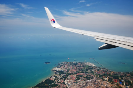 KUALA LUMPUR, MALAYSIA - MAY 09, 2015: Malaysia Airlines airplane wing with MAS logo on the sky. Malaysia Airlines behad is the flag carrier of Malaysia and a member of the Oneworld airline alliance.のeditorial素材