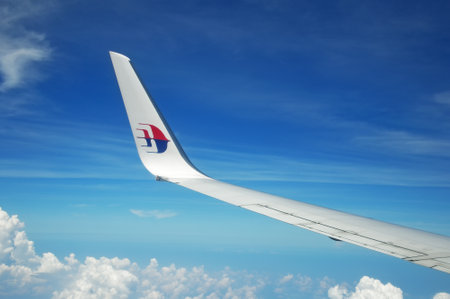 KUALA LUMPUR, MALAYSIA - MAY 09, 2015: Malaysia Airlines airplane wing with MAS logo on the sky. Malaysia Airlines behad is the flag carrier of Malaysia and a member of the Oneworld airline alliance.のeditorial素材