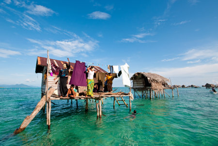 Semporna, Malaysia - 17 September, 2011: Bajau laut in their floating village of stilted houses off the coast of Borneo in The Celebes Sea in the vicinity of Sipidan and Tun Sakaran Marine Park.のeditorial素材