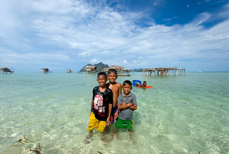 Semporna, Malaysia - April 17: 2015 Young bajau laut boys playing at the beach in Maiga Island in the vicinity of Sipidan Island and Tun Sakaran Marine Parkのeditorial素材
