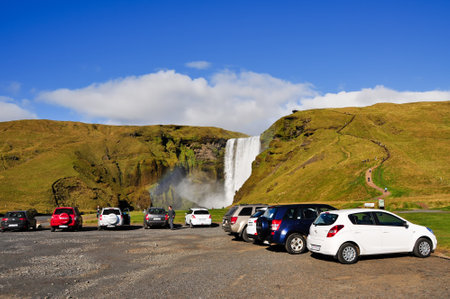 Skoga, Iceland - September 18, 2013: Car and vehicle parking at the parking lot in Skogafoss waterfall area, one of the must see attraction in Iceland.のeditorial素材