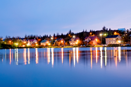 Night view downtown Reyjkjavik over the Tjornin lake in Iceland.の写真素材
