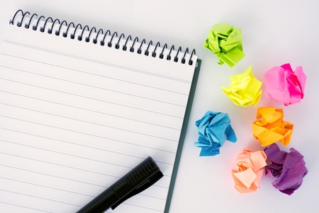 Notepad and crumpled paper ball - brainstorming office concept.