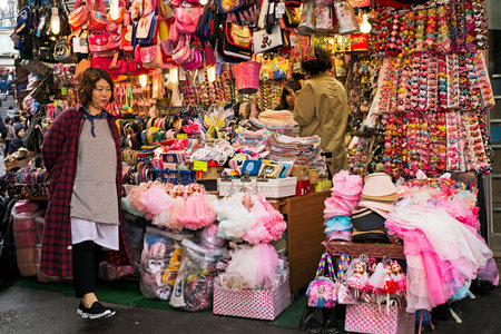 Seoul, Korea - April 04, 2017: Woman in front of the souvenir shop in Namdaemun market. Namdaemun market is a large traditional market in Seoul, South Korea.のeditorial素材