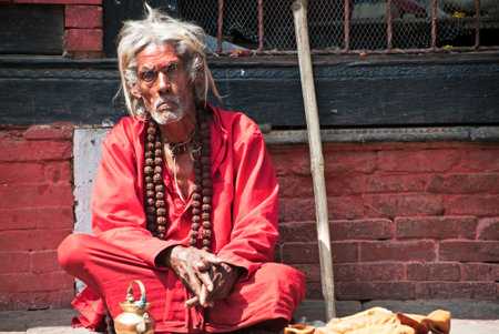 Kathmandu, Nepal - March 9, 2013: Lone sadhu in Pashupanith Temple. A sadhu is a religious ascetic, mendicant or any holy person in Hinduism and Jainism who has renounced the worldly life.のeditorial素材