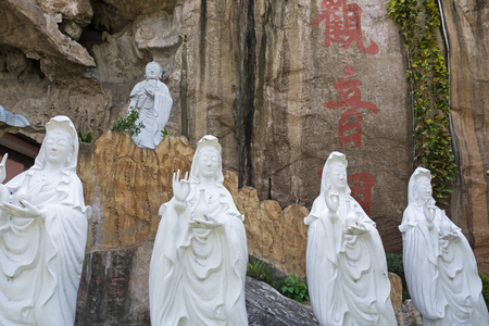 Buddha statues at Perak Kwan Yin Tong temple in Ipoh, Perak, Malaysia. Built beside a limestone hill, this ancient Buddhist temple honors goddess of mercy Kwan Yin Tong.の写真素材