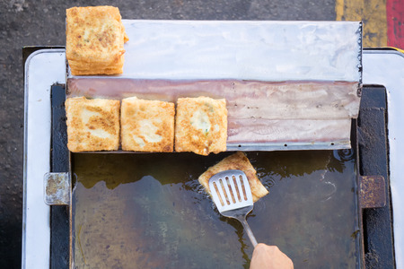 Top view of a hand cooking vegetables martabak jawa in Kota Kinabalu City open market in Sabah Borneo. Martabak Jawa also known as stuffed pancake or pan-fried bread, murtabak and mutabbaq.の写真素材