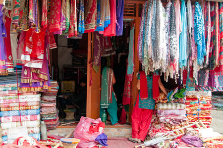 Textile and souvenir shop selling colorful sari, clothes and shawl in Bhaktapur, Kathmandu Valley, Nepal.のeditorial素材