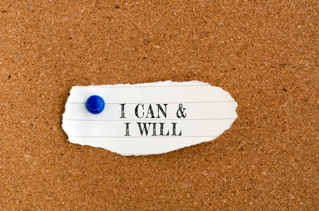 Inspirational quote on piece of paper - I can and i will.の写真素材