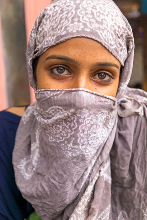 Mandawa, India - February 24, 2018: Portrait of a young Indian girl with headscarf.