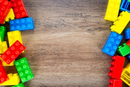Colorful toy building blocks on wood background.の写真素材