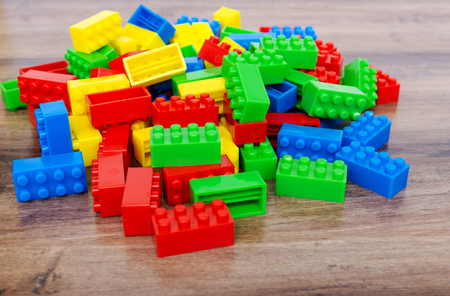 Colorful toy building blocks on wood background.の写真素材