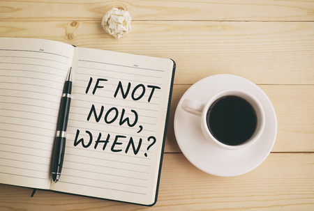 If not now, when? text on notepad and pen with coffeeの写真素材