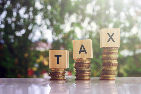 Wooden blocks with text TAX. Business and finance concept.の写真素材