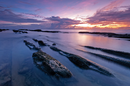 Sunrise with rocky foreground, Bak Bak beach in Kudat, Sabah Malaysiaの写真素材