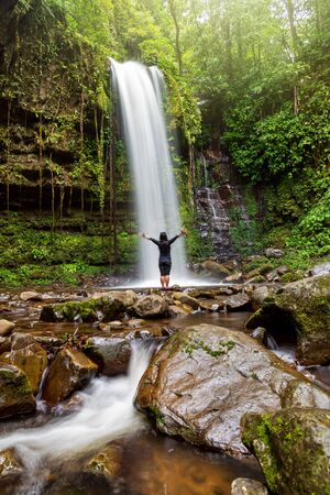 Unidentified Woman Standing at Mahua Waterfall in Crocker Range National Park Tambunan Sabah Borneo Malaysiaの写真素材