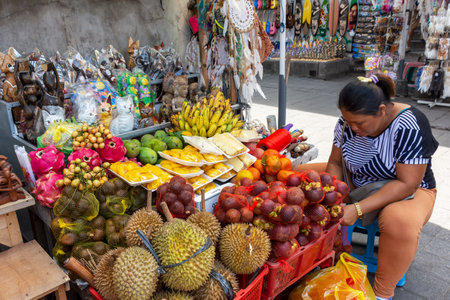 Ubud, Indonesia - September 17, 2018: Woman selling variety of fruits at Ubud Market.のeditorial素材