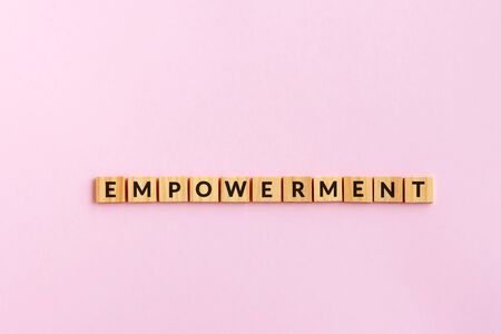 Empowerment text wood blocks. Pink background.の写真素材