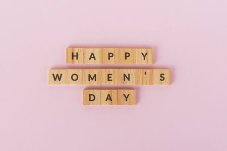 Happy Women's text on wood blocks. Pink background.の写真素材