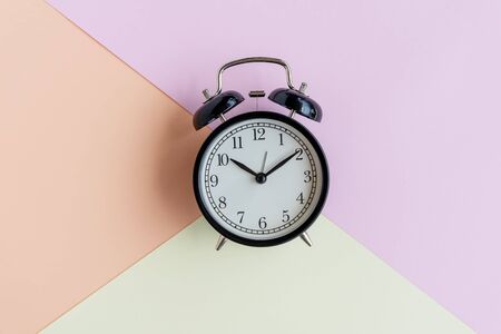 Alarm clock on pastel background - still life conceptual