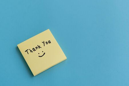 Thank you note on stocky note on blue backgroundの写真素材