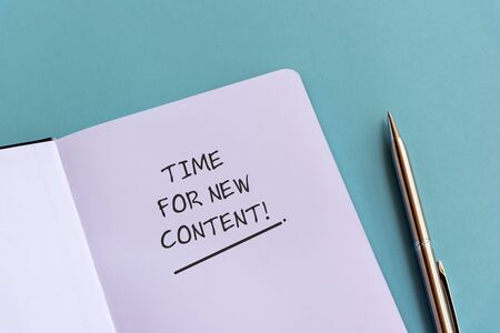 Inspirational quotes text on note pad - Time for new content.