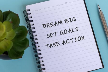 Inspirational quotes text on note pad - Dream big, Set goals, Take action.の写真素材