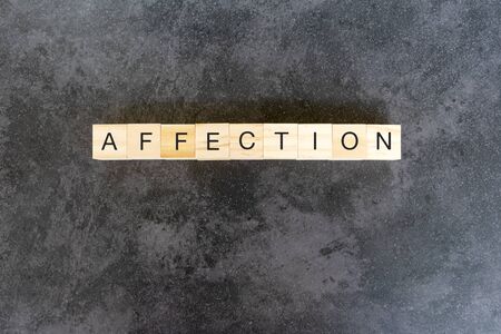 Affection text on wooden block on black texture backgroundの写真素材