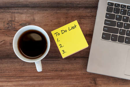 To do list text on adhesive paper note with laptop and cup of coffee and penの写真素材