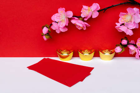 Sakura Blossom, Golden Ingot and Red Envelope on White and Red Backgroundsの写真素材