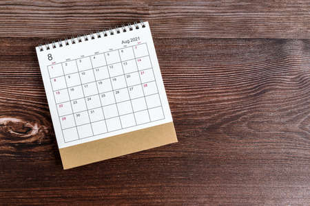 August Desk Calendar 2021 on Top of Wooden Background