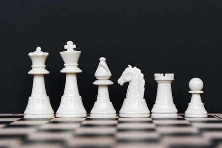 Set of White Chess Pieces on Black Backgroundの写真素材