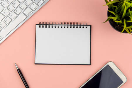 Flat lay office desk with note pad and computer keyboard